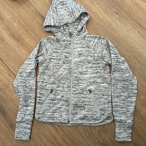 Athleta girls jacket with hood. Color gray/black. Thumb can go through sleeve.